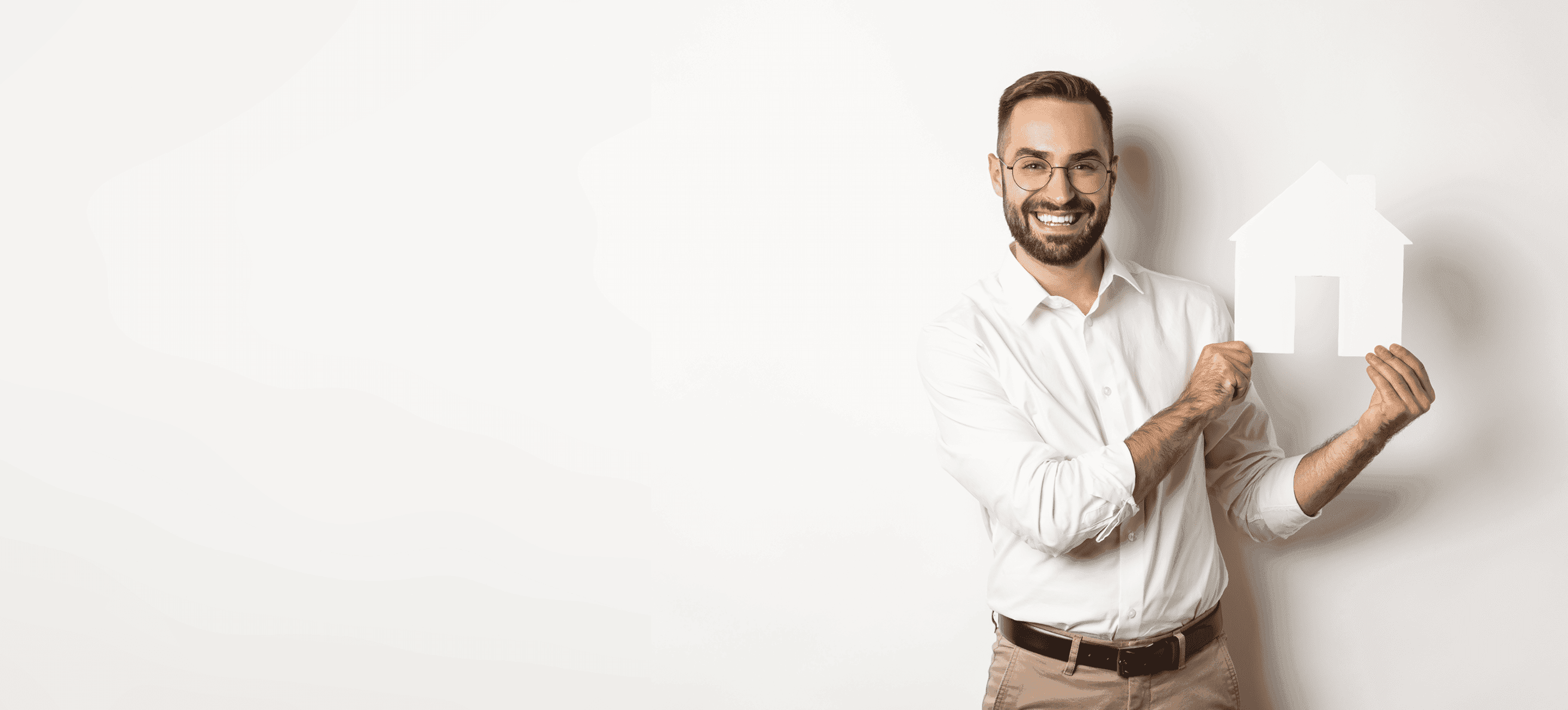 Man holding paper cutout of a house